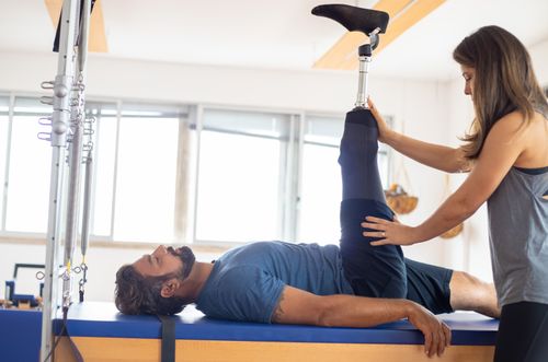 A therapist guiding a patient through a rehabilitation exercise