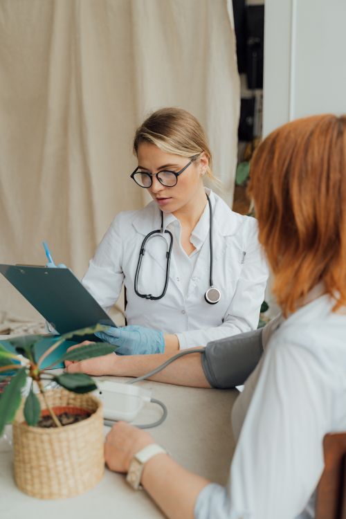 A female doctor checking a patient during a health visit